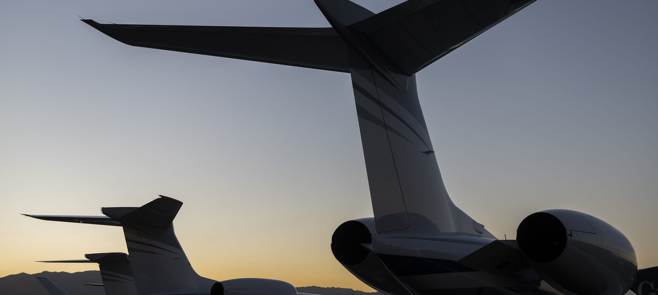 Tail section of Gulfstream Jets at sunset; learn about distressed air carriers