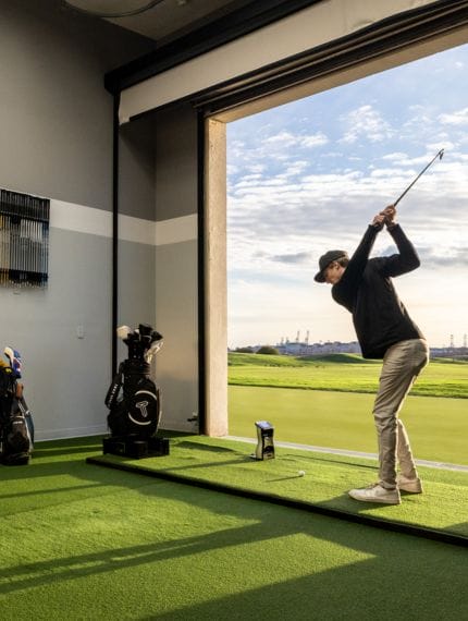 a golfer swinging inside the true spec golf fitting area
