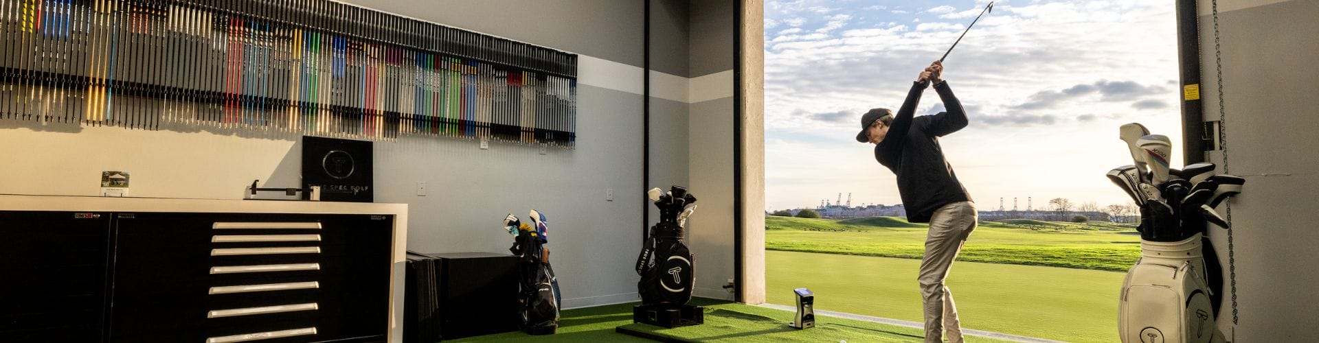 a golfer swinging inside the true spec golf fitting area