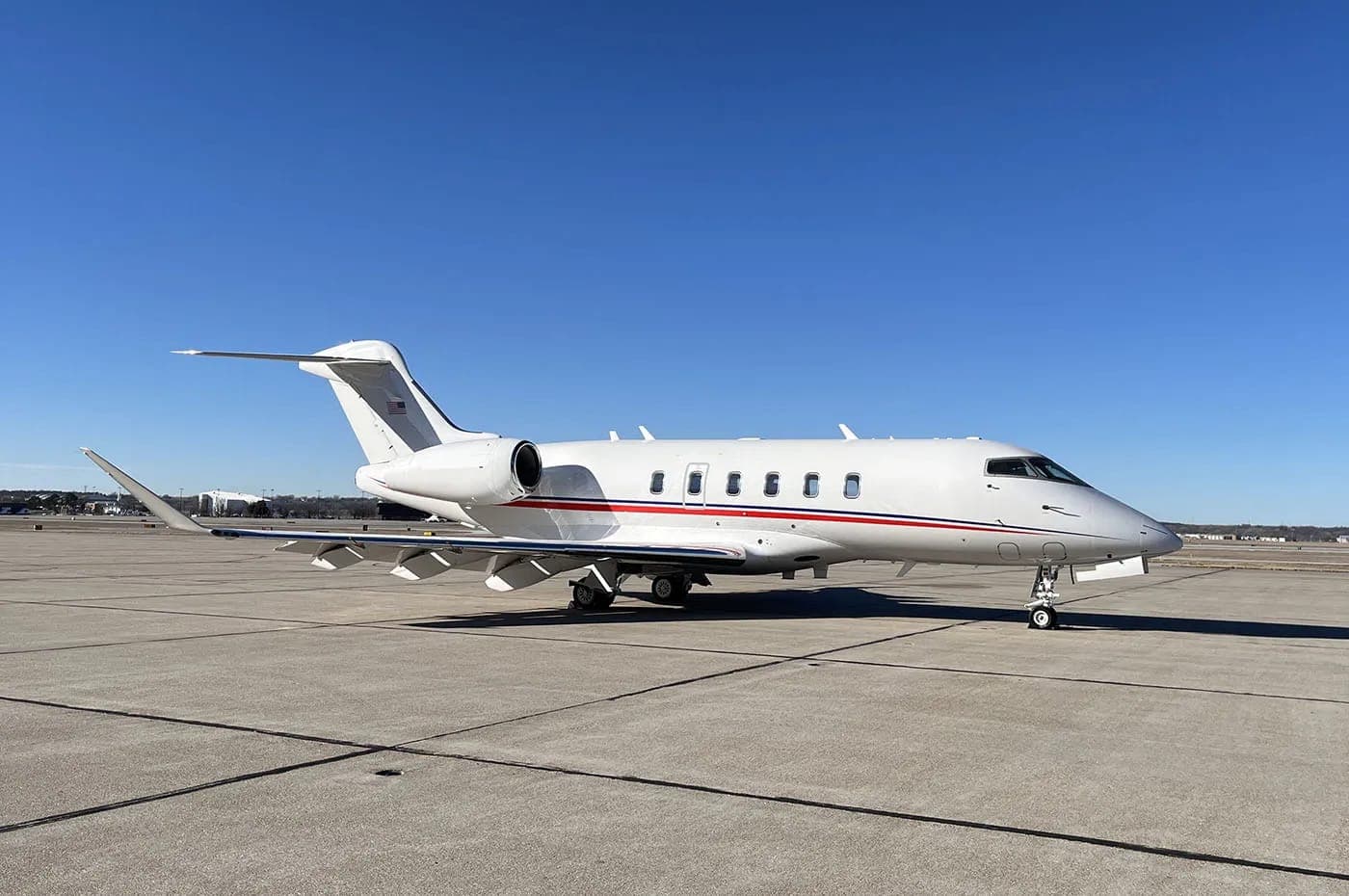 Bombardier Challenger 350 jet in flight, showcasing its redesigned winglets