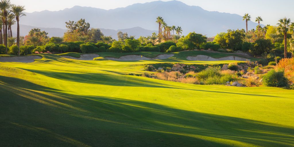Beautiful golden light over Indian Wells Golf Resort, a desert golf course in Palm Springs, California, USA with view of the San Bernardino Mountains.