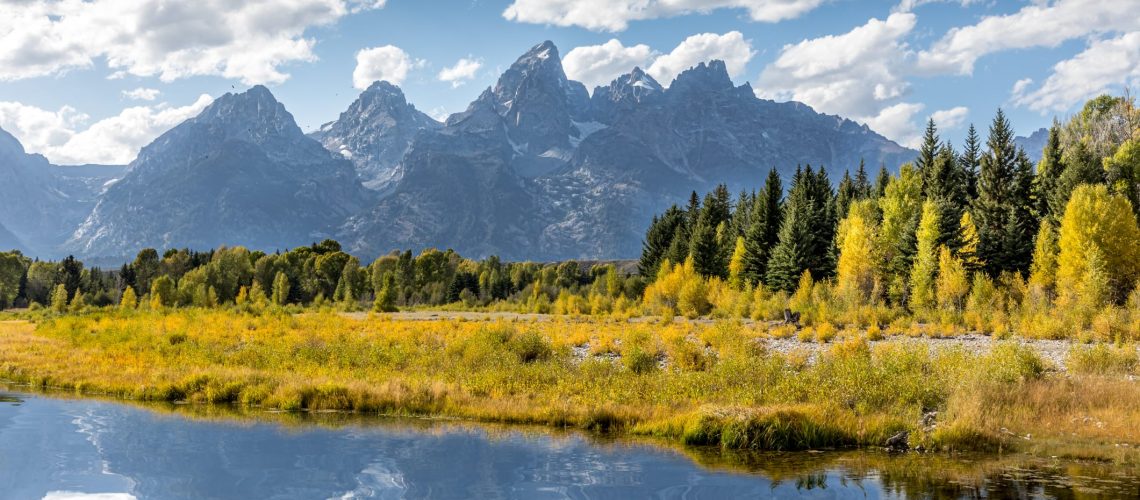 Jackson Hole Guide: View of the Grand Teton Mountains from Schwabacher Landing on the Snake River. Grand Teton National Park, Wyoming, United States.